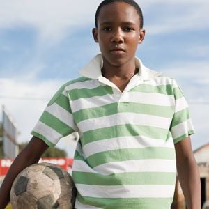 teenage-african-boy-with-football-2022-03-07-23-57-32-utc
